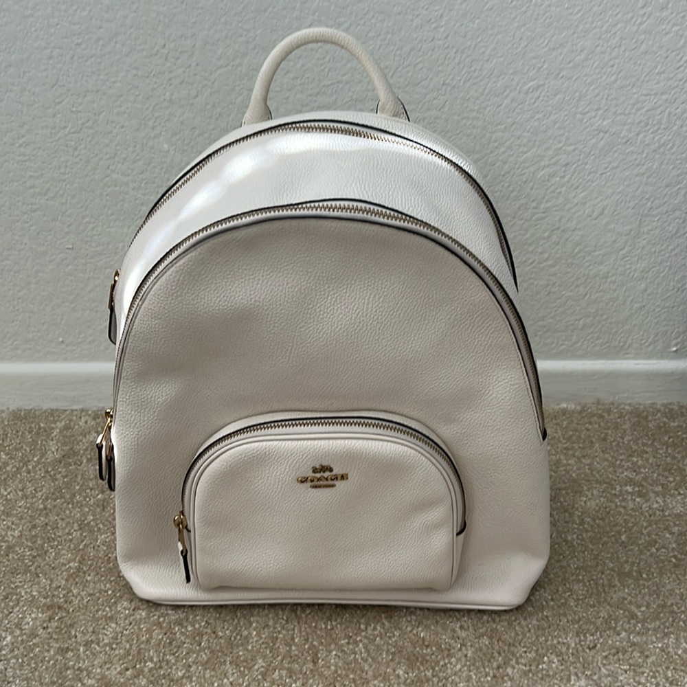 Coach cream colored backpack. 3 pockets (2 big, 1 small)